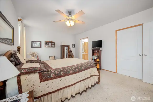 View of Main bedroom with entries to bathroom and walk in double closet.