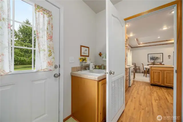Easy access and could serve as a mud room, notice the utility sink also in the Laundry room.
