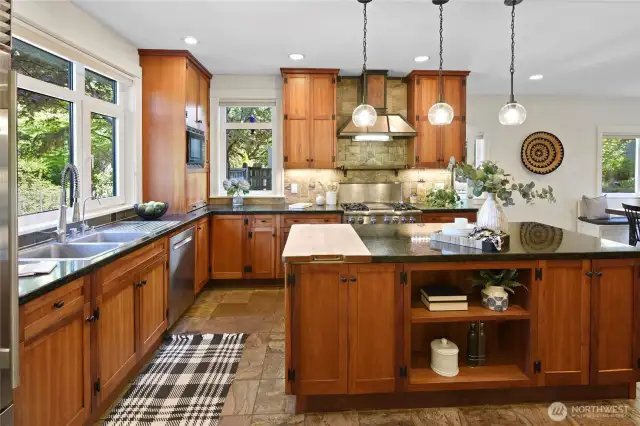 Luxurious chef's kitchen features custom cherry cabinetry and granite countertops.