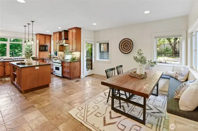 Kitchen opens to custom built in bench seating and table - stays with house. Door in center left leads to sauna.