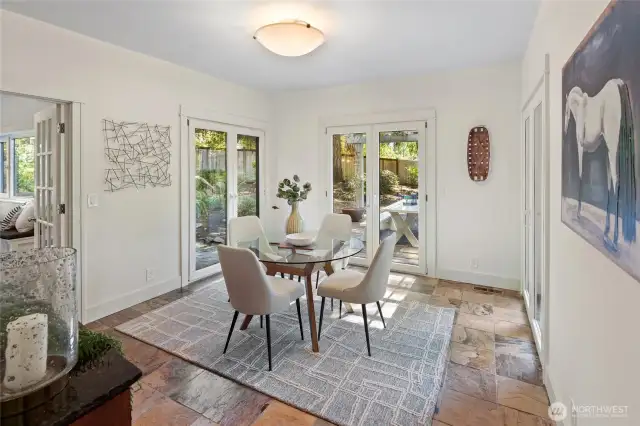 Dining room with three sets of French doors for convenient access to beautiful patio