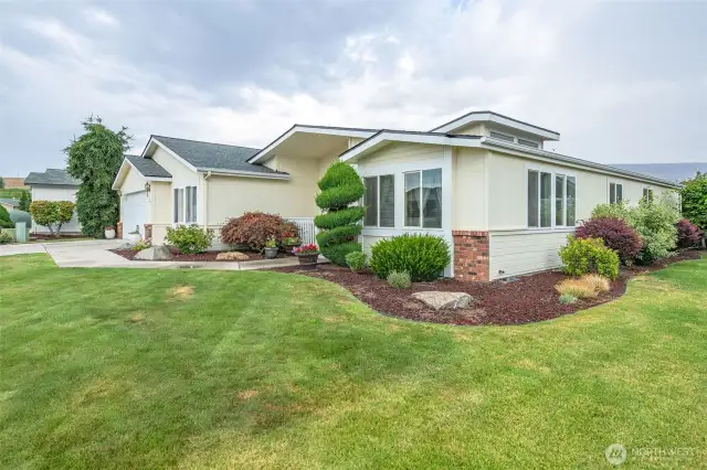 Brick wainscot siding, manicured landscape and beautiful architecture set this home apart!