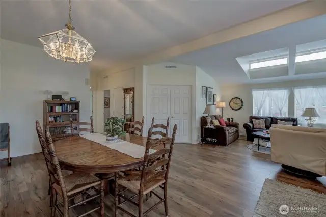Notice warm wood LVP floors and lots of light!