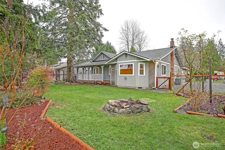 Fully fenced front yard with gardens, firepit, and chicken coop!