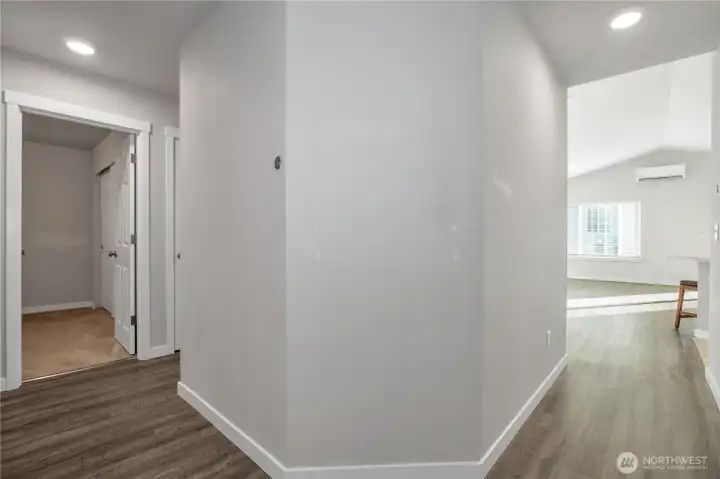 hallway to additional bedrooms, Laundry Room, and garage access