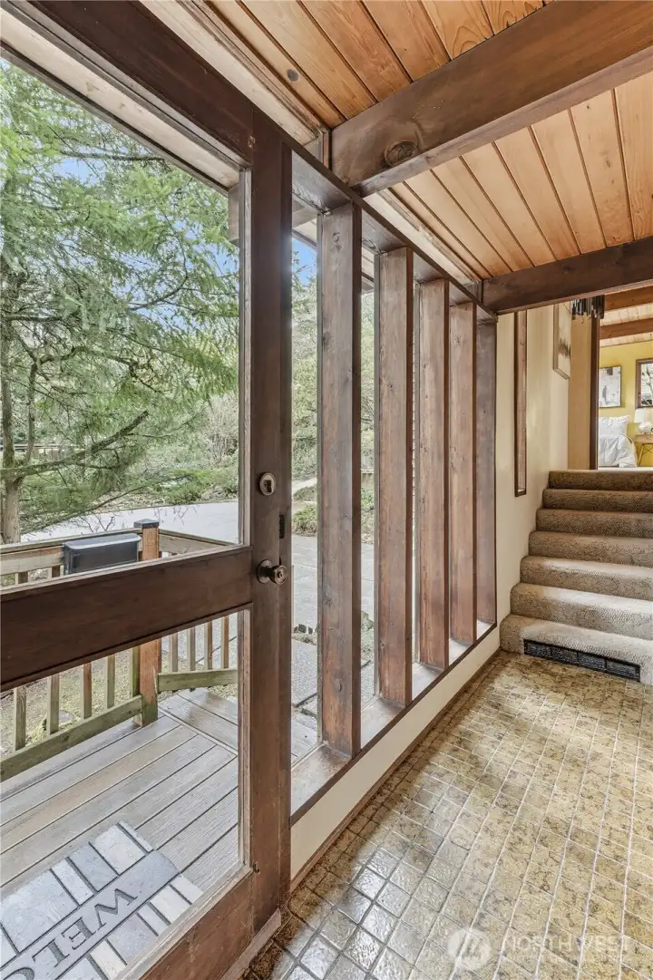 The front entry and the stairs leading to the bedroom level.