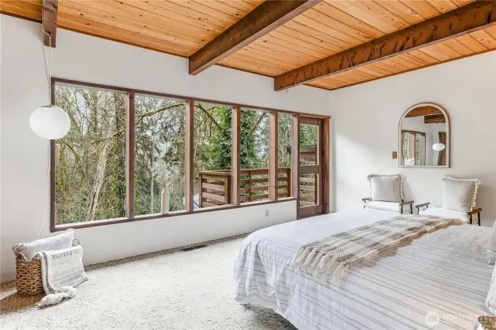 The primary bedroom with territorial views and a private balcony.