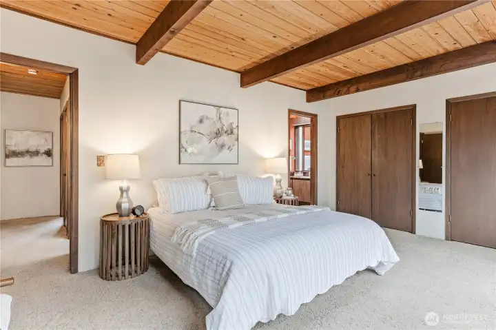 An alternate view of the primary bedroom looking toward the en-suite bathroom.