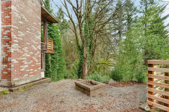 The side yard with fire pit is partially fenced.