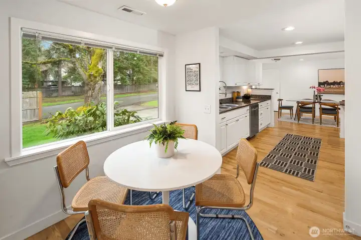 Looking from your sweet dining nook towards your bright kitchen.