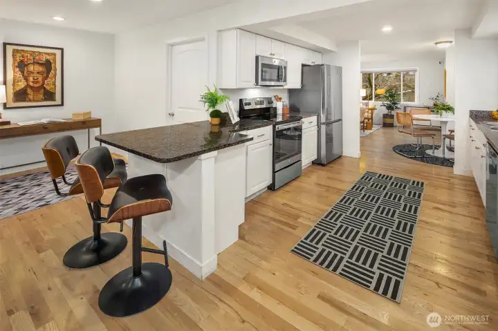 sweet counter seating really takes advantage of all of the space! The door beyond the kitchen leads to your large utility room.