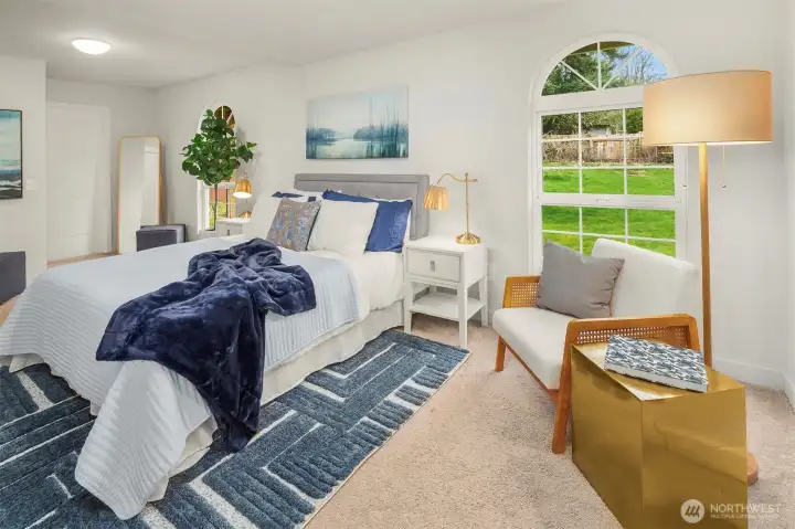 There is a second primary suite that lives on the main floor. Such gorgeous windows in this large space!