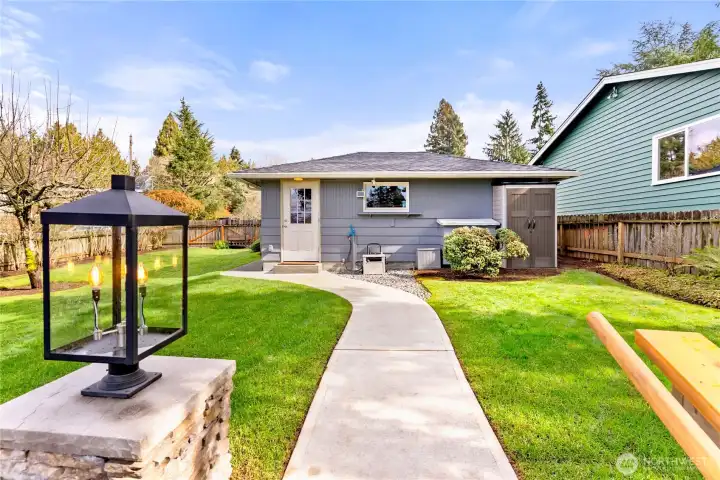 Double garage in backround. Electric car charger. Has it's own electric panel, sewer/water brought up to garage ready to plumb in, all underground. Second floor add on   garage  for ADU with swiping views. 5 extra parking spots. Perfesionally landscaped and utter perfection!