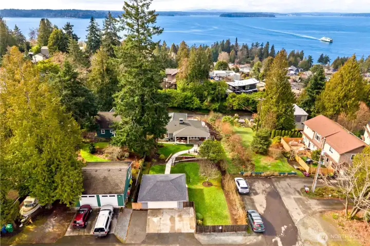 Located in one of West Seattle's premier neighborhoods. Positioned high above Lincoln Park to take in stunning views. Area to the right is city's vacated dead end street. Off street parking for 5 cars, and a two car garage.