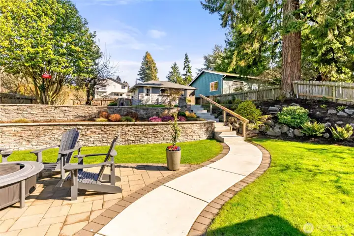 Double garage in backround. Electric car charger. Has it's own electric panel, sewer/water brought up to garage ready to plumb in, all underground. Second floor add on   garage  for ADU with swiping views. 5 extra parking spots. Perfesionally landscaped and utter perfection!