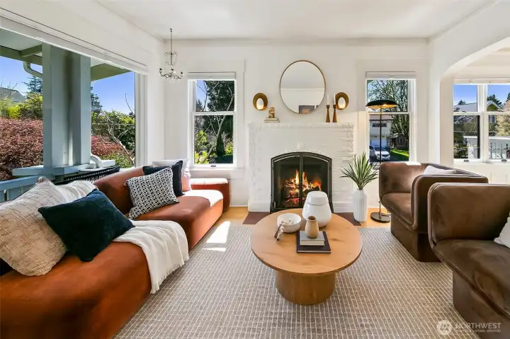 Sun-drenched living room has newly installed gas fireplace, hardwood floors & great light.
