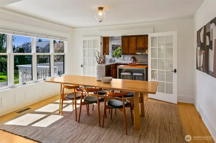 Flow basking in south-facing light to the large dining room. Note all the new windows and beautiful French doors towards the kitchen. Picture ledges still intact!