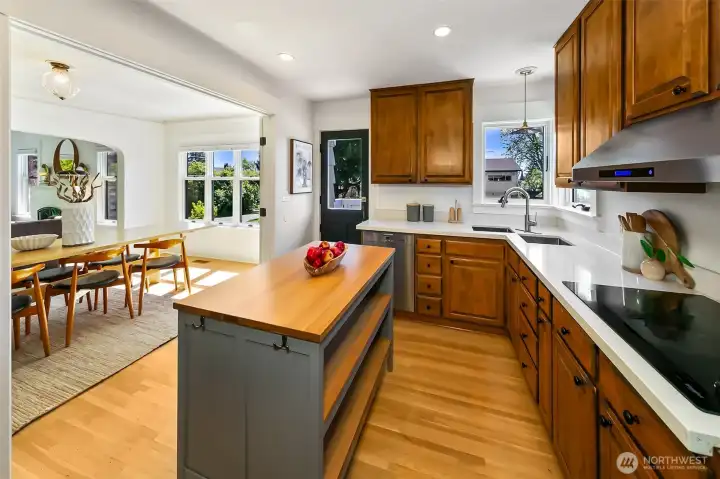 View of the kitchen towards the deck. The charming stable door lets more light in. Open for a nice breeze or use the heat pump (A/C)