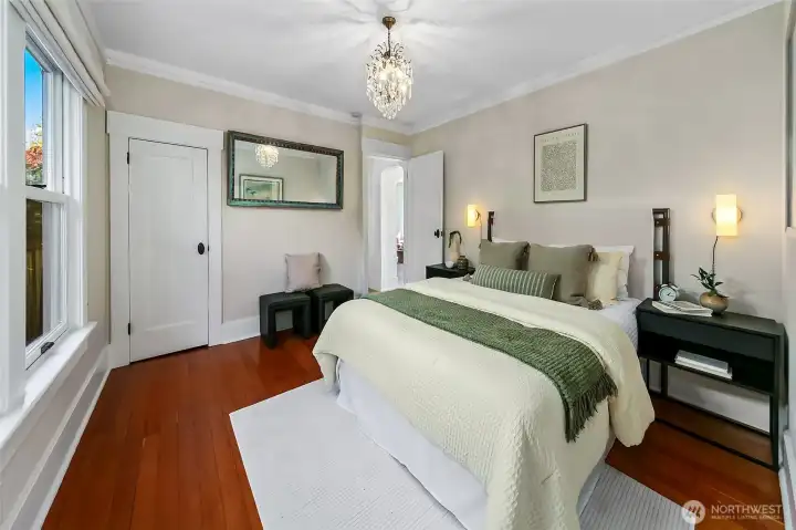 Primary bedroom on the main level has two closets. Large walk-in closet to the right. Spacious enough for multiple configurations and tucked off the main living area to feel like your own private suite.