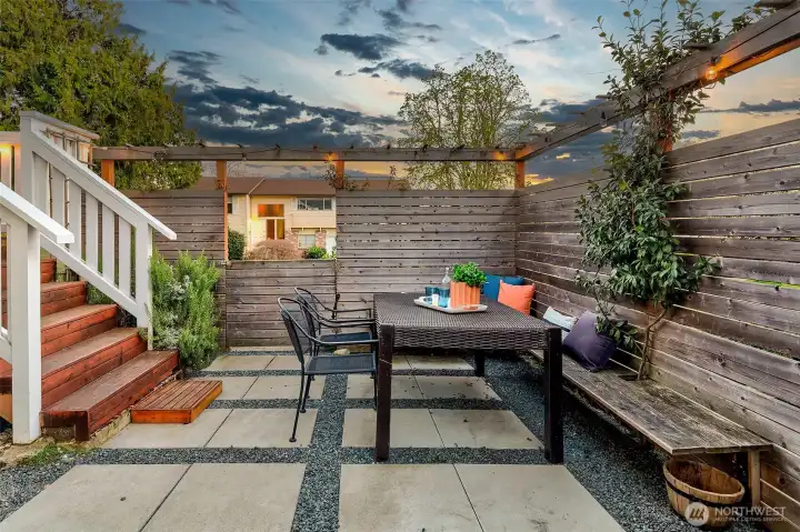 From the deck flow to built-in dining space in the private backyard.