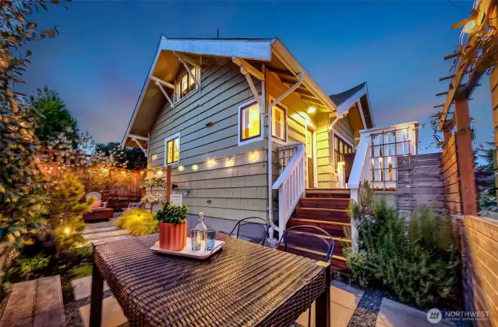View from the backyard toward the deck. The kitchen steps out onto the deck for easy BBQ and entertaining.