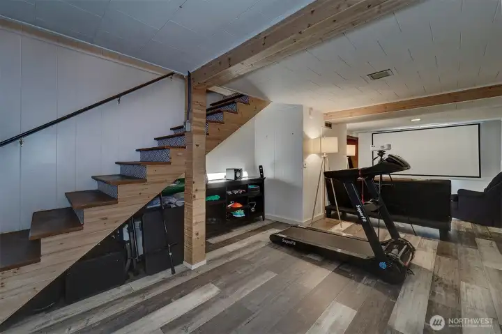 As we head downstairs, you will find a multi-purpose space (with closet) to use however you wish.