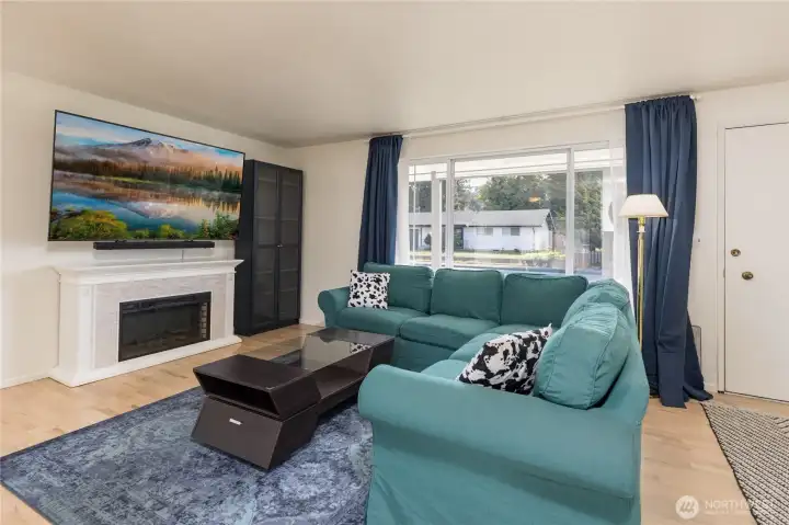 Sun-drenched living space highlighting the gorgeous hardwood floors refinished in 2022