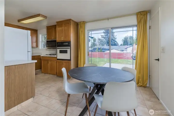 Dedicated dining space with slider access to the back yard