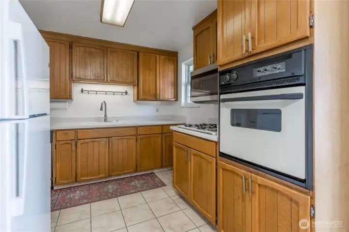 Bright and functional kitchen featuring a brand-new fridge and ample storage