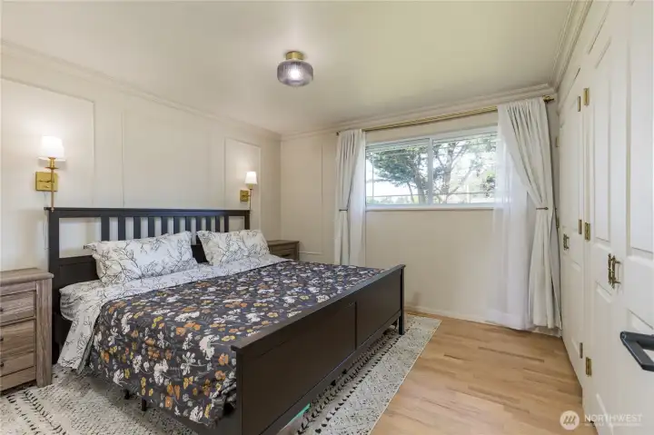 Spacious primary bedroom with dual closets and elegant millwork
