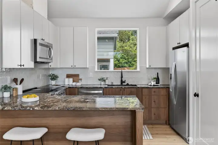 Features include stainless steel appliances, custom cabinetry, marble countertops, and a walk-in pantry.