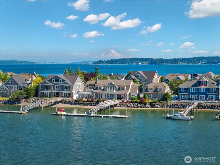 Set on a rare double lot with approximately 140 feet of waterfront frontage, the timeless shingle-style residence showcases over 6,600 square feet of thoughtfully designed living space & a private deep-water dock capable of accommodating a 90-foot yacht plus two additional 40-foot guest vessels.