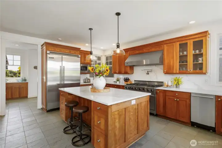 Slate flooring, custom cherry cabinetry and high end appliances.