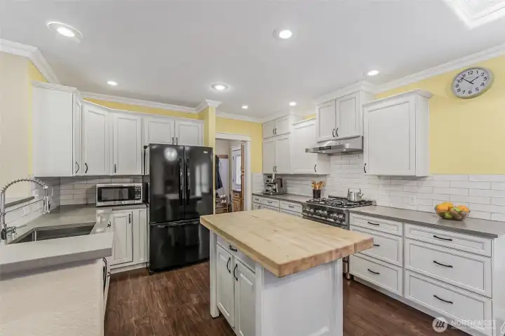 New custom quartz kitchen with center butcher block island.