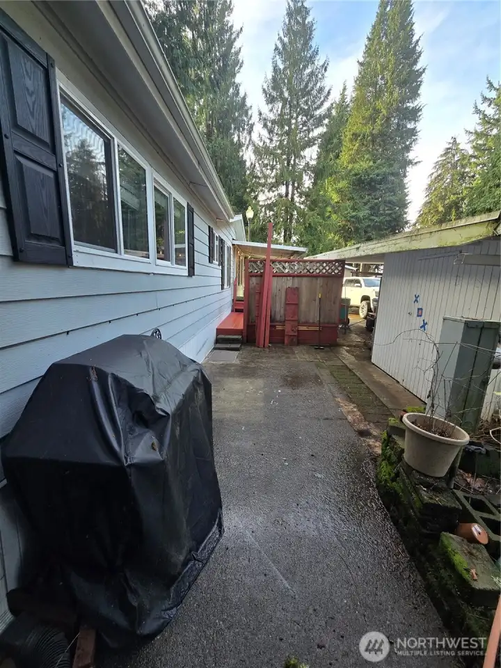 Another angle of patio area and storage shed off carport Another angle of patio area and storage shed off carport