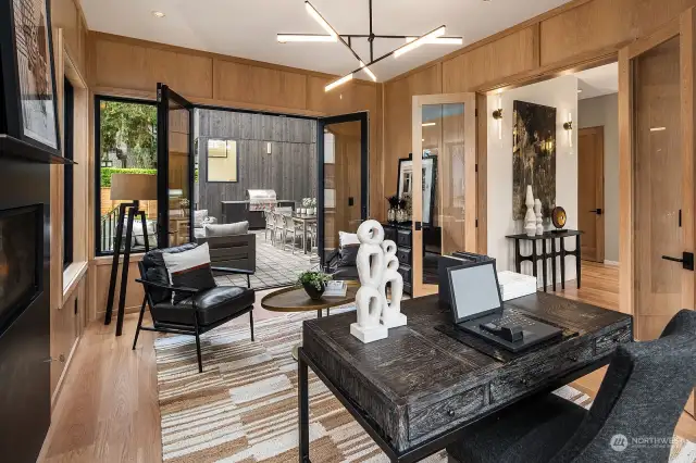 a standalone glass cube - serving as a study, is perfectly positioned off the atrium to receive visitors without impacting privacy. The space is further enhanced with white oak wrapped walls and a floor to ceiling Vermont black honed Basaltino fireplace.