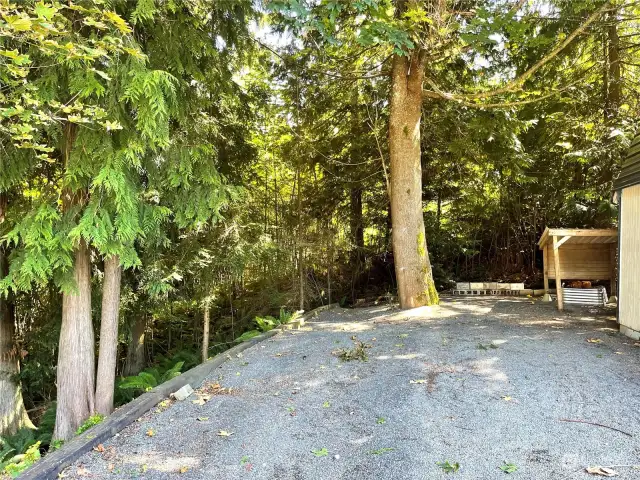 Along side the shed is a garage ready area. Property goes down to the stake on the left.