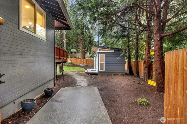 Right side of the main house, gated entry to the back yard leads to the backyard via cement pad and flagstone pathway