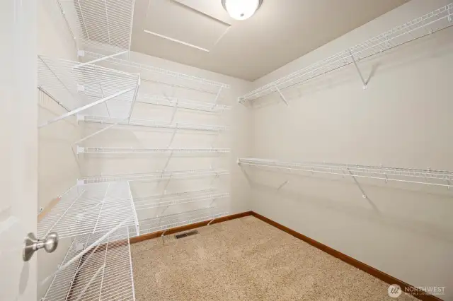 The walk-in closet is just inside the primary bathroom and has a lot of hanger space.