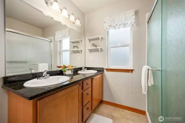 The 3/4 bath is also at the top of the stair landing and has a large 2 sink vanity.