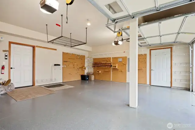 The garage is oversized for two vehicles and has all kinds of storage. There is a door that opens to the side yar as well.