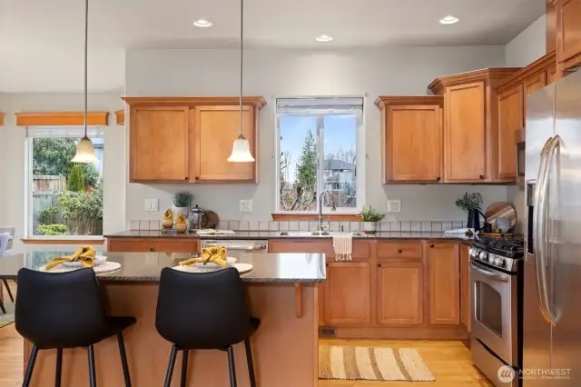 The eating bar at the island allows for additional seating, and the kitchen faces south and looks out to the rear yard.
