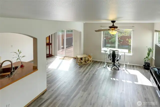 As you enter the home and look to the right, you'll see the living room in front, dining at far left and kitchen at near left.