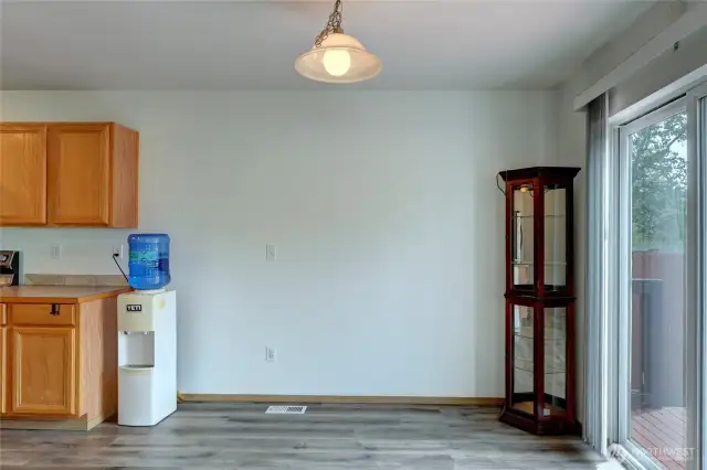 Dining room is at the far end of the kitchen and also open to living room.