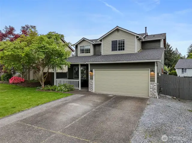 With extended driveway and fresh sod in front yard.