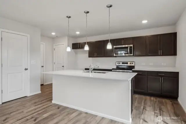 Open concept living/dining/kitchen-Discalimer-Disclaimer- Photos are of another Lina floor plan from a previous community, photos are for illustrative purposes only. Finishes, flooring, upgrades, or other features may vary.