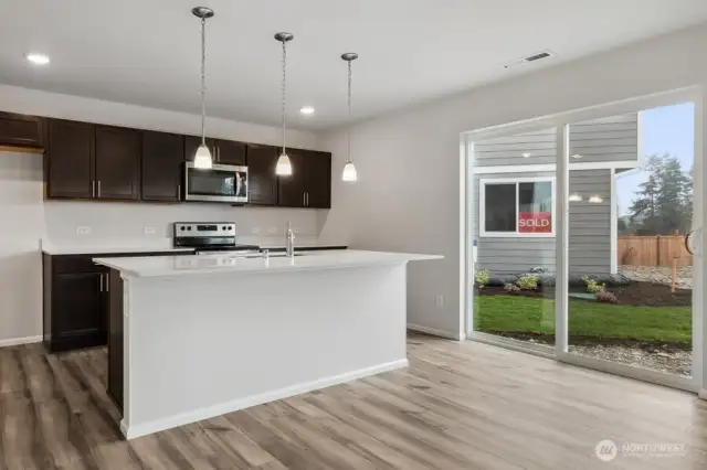 Open concept living/dining/kitchen-Discalimer-Disclaimer- Photos are of another Lina floor plan from a previous community, photos are for illustrative purposes only. Finishes, flooring, upgrades, or other features may vary.