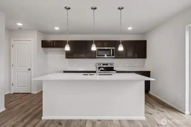 Open concept living/dining/kitchen-Discalimer-Disclaimer- Photos are of another Lina floor plan from a previous community, photos are for illustrative purposes only. Finishes, flooring, upgrades, or other features may vary.