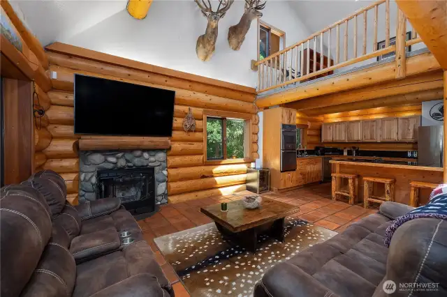 Wood burning fireplace provides warmth and ambiance during chilly evenings, creating the perfect setting for unwinding with a good book.