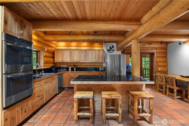 Gourmet kitchen: Features high-end finishes, custom cabinetry, and modern appliances, blending rustic elegance with functionality.